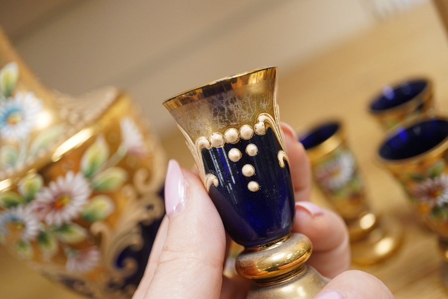 A Royal Worcester peacock painted jar and cover and a Bohemian blue glass decanter and six glasses, with gilt and enamel decoration, decanter 26cm high including stopper. Condition - finial to Worcester pot cover chipped